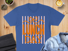 Load image into Gallery viewer, Blue t-shirt with "LUNCH DAY" text in orange stripes.