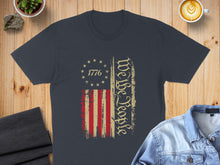 Load image into Gallery viewer, Dark t-shirt with distressed American flag and "We The People" text.