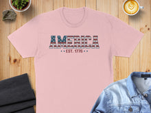 Load image into Gallery viewer, Pink t-shirt with "AMERICA EST. 1776" text in distressed flag design.