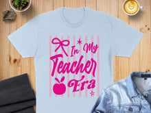 Load image into Gallery viewer, Light blue t-shirt with pink text "In My Teacher Era" on pink stripes.