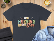 Load image into Gallery viewer, Dark gray t-shirt with "Nursing is in my DNA" text and colorful medical graphic.
