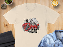 Load image into Gallery viewer, Cream t-shirt with "The Cool Dad" text and mountain graphic.