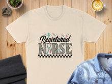 Load image into Gallery viewer, Cream t-shirt with "Registered Nurse" in colorful, patterned letters and medical icons.