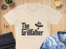 Load image into Gallery viewer, Cream t-shirt with "The Grillfather" text and a fork with a sausage.