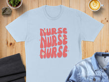 Load image into Gallery viewer, Light blue t-shirt with "Nurse Nurse Nurse" text and flowers.