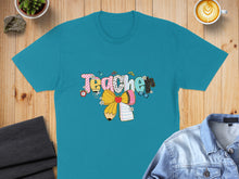 Load image into Gallery viewer, Teal t-shirt with colorful "Teacher" text and school supplies design.