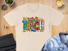 Load image into Gallery viewer, "Made to Teach" text design with art supplies and fruit.