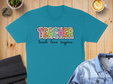 Load image into Gallery viewer, Teal t-shirt with "TEACHER" in colorful polka dot letters and "teach love inspire" below.