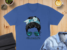 Load image into Gallery viewer, Blue t-shirt with messy bun nurse graphic and #NurseLife hashtag.