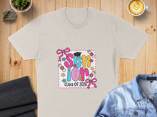 Load image into Gallery viewer, Cream t-shirt with "Senior Class of 2026" text, diplomas, and bows.