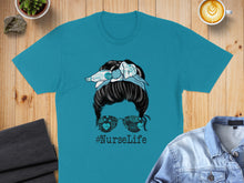 Load image into Gallery viewer, Turquoise t-shirt with a messy bun hairstyle and sunglasses with medical icons.