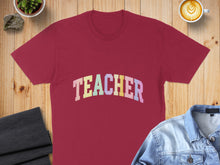 Load image into Gallery viewer, Maroon t-shirt with "TEACHER" in colorful pastel lettering.