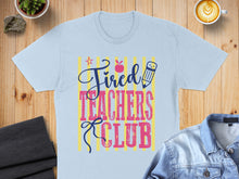 Load image into Gallery viewer, Light blue t-shirt with "Tired Teachers Club" text and apple graphic.