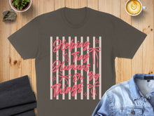 Load image into Gallery viewer, Brown t-shirt with pink ribbon and "Helping Tiny Humans Do Big Things" text.