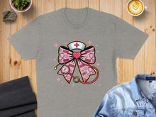 Load image into Gallery viewer, Grey t-shirt featuring a pink bow with stethoscope, hearts, and "XOXO".