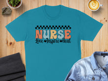 Load image into Gallery viewer, Teal t-shirt with "Nurse Love Inspire Heal" text and checkered pattern.