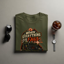 Load image into Gallery viewer, Green t-shirt with "When Everything Else Fails" radio graphic and outdoor scene.