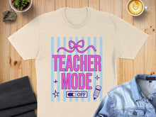 Load image into Gallery viewer, T-shirt with "Teacher Mode Off" text and bow graphic on a pastel striped background.