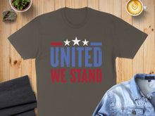 Load image into Gallery viewer, Brown t-shirt with "UNITED WE STAND" text and stars, on wooden surface.