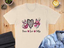 Load image into Gallery viewer, Cream t-shirt with "Peace love CMA" design featuring stethoscope, syringe, and leopard print heart.