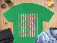 Load image into Gallery viewer, Green t-shirt with pink text "Helping Tiny Humans Do Big Things" and ribbon graphic.