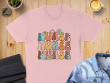 Load image into Gallery viewer, Pink t-shirt with "Nurse Nurse Nurse" text in colorful, floral, retro font.