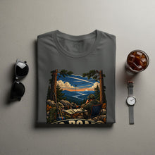 Load image into Gallery viewer, Grey t-shirt with a graphic of a person operating radio equipment in a mountain landscape.