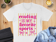 Load image into Gallery viewer, White t-shirt with pink text "Reading is my favorite sports" and decorative bows.
