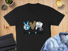 Load image into Gallery viewer, Black t-shirt with peace sign, leopard print heart, tooth, and dental tools.