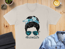 Load image into Gallery viewer, Nurse Life graphic on a t-shirt with messy bun and medical symbol sunglasses.