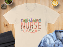 Load image into Gallery viewer, Cream t-shirt with "registered NURSE" text and a pink syringe graphic.