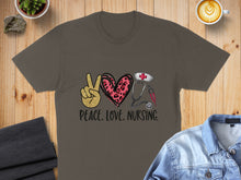 Load image into Gallery viewer, Brown t-shirt with peace sign, heart, stethoscope, and coffee cup graphics.