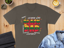 Load image into Gallery viewer, Black Dad text art with crown, fists, and stars, on a dark gray t-shirt.