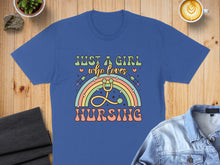 Load image into Gallery viewer, Blue t-shirt with "Just a girl who loves nursing" text and rainbow stethoscope design.