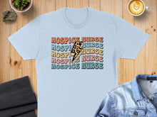 Load image into Gallery viewer, Light blue t-shirt with "Hospice Nurse" in colorful retro lettering.