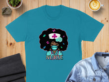 Load image into Gallery viewer, Turquoise t-shirt with cartoon nurse graphic, wearing a face mask and stethoscope.