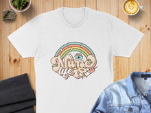 Load image into Gallery viewer, White t-shirt with "Nurse Life" text and rainbow, syringe, and heart graphics.