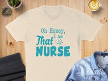 Load image into Gallery viewer, Cream t-shirt with "Oh Honey, I am That Nurse" in teal text.