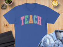 Load image into Gallery viewer, Blue t-shirt with colorful "TEACH" text in arched block letters.