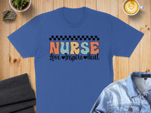 Load image into Gallery viewer, Blue t-shirt with "Nurse Love Inspire Heal" text and checkered border.