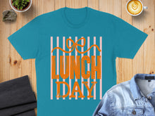 Load image into Gallery viewer, Teal t-shirt with "LUNCH DAY" text and orange stripes.