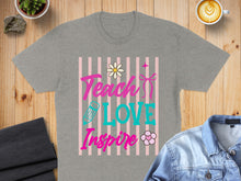 Load image into Gallery viewer, "Teach Love Inspire" text with flowers and pencil on a grey t-shirt.