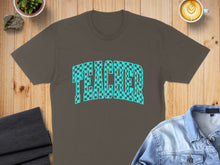 Load image into Gallery viewer, Brown t-shirt with checkered "TEACHER" text design, laid flat with coffee and denim jacket.