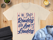 Load image into Gallery viewer, T-shirt with "Readers Are Leaders" text and bow graphic.