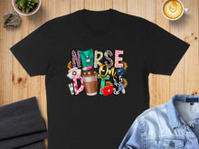 Load image into Gallery viewer, Black t-shirt with "Nurse Fuel" text, coffee cup, stethoscope, and medical icons.
