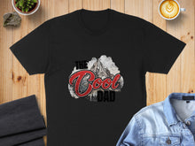Load image into Gallery viewer, Black t-shirt with "The Cool Dad" text and mountain graphic.