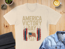 Load image into Gallery viewer, Cream t-shirt with "AMERICA VICTORY DAY MAY 08" and American flag graphic.