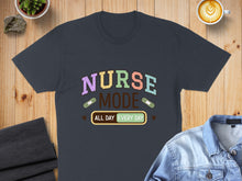 Load image into Gallery viewer, Dark t-shirt with "Nurse Mode All Day Every Day" text and colorful bandages.