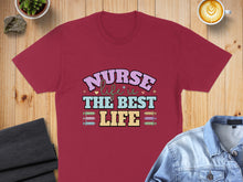 Load image into Gallery viewer, Burgundy t-shirt with "Nurse The Best Life" text and medical syringe graphics.