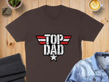 Load image into Gallery viewer, Brown t-shirt with "TOP DAD" in distressed white, red, and black lettering.